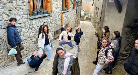 Participants larking about in a narrow stone street of the mountain village