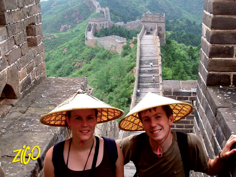 Participants on the Great Wall in conical hats