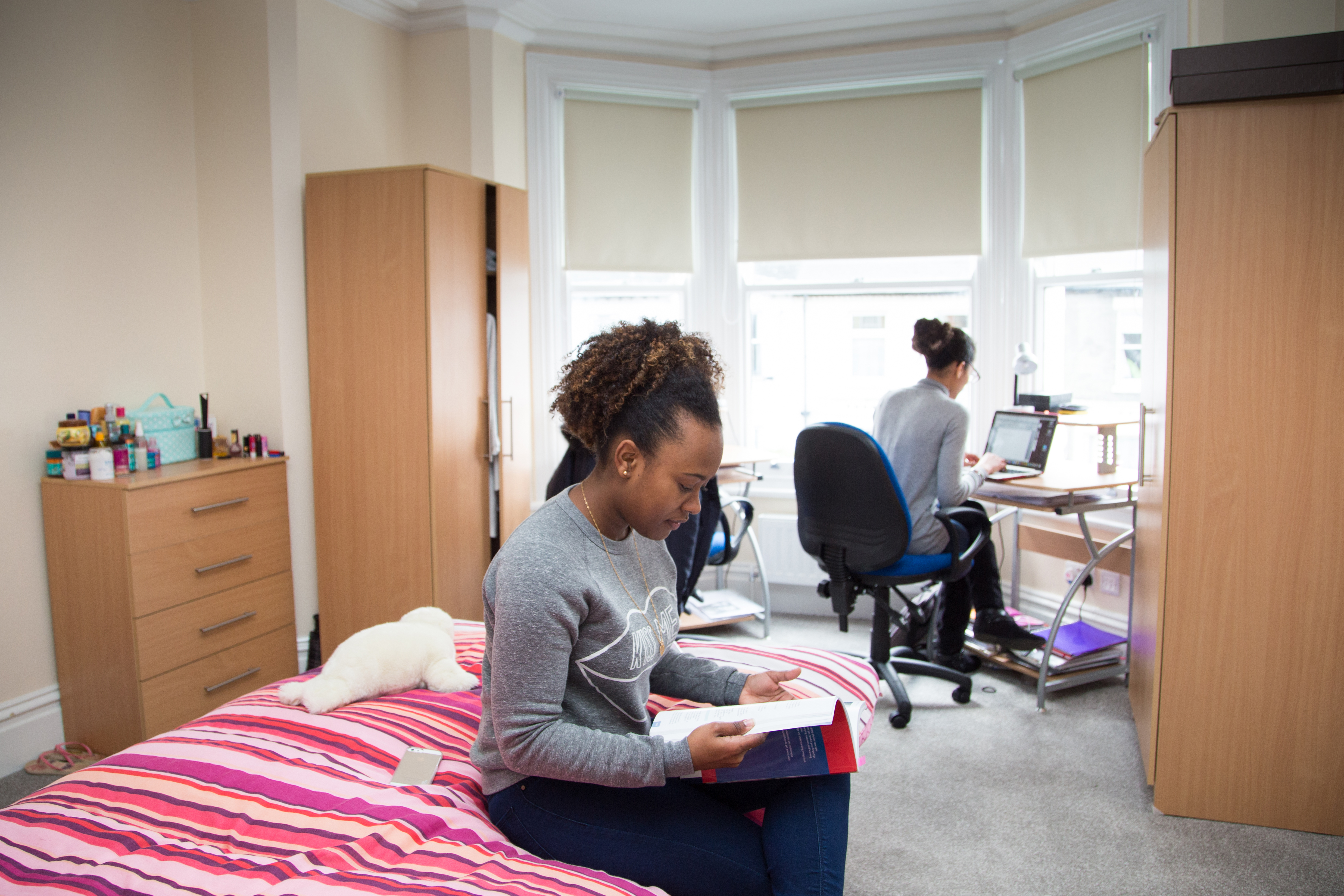Students working at a table in a bright bay-window classroom at the Station Road site