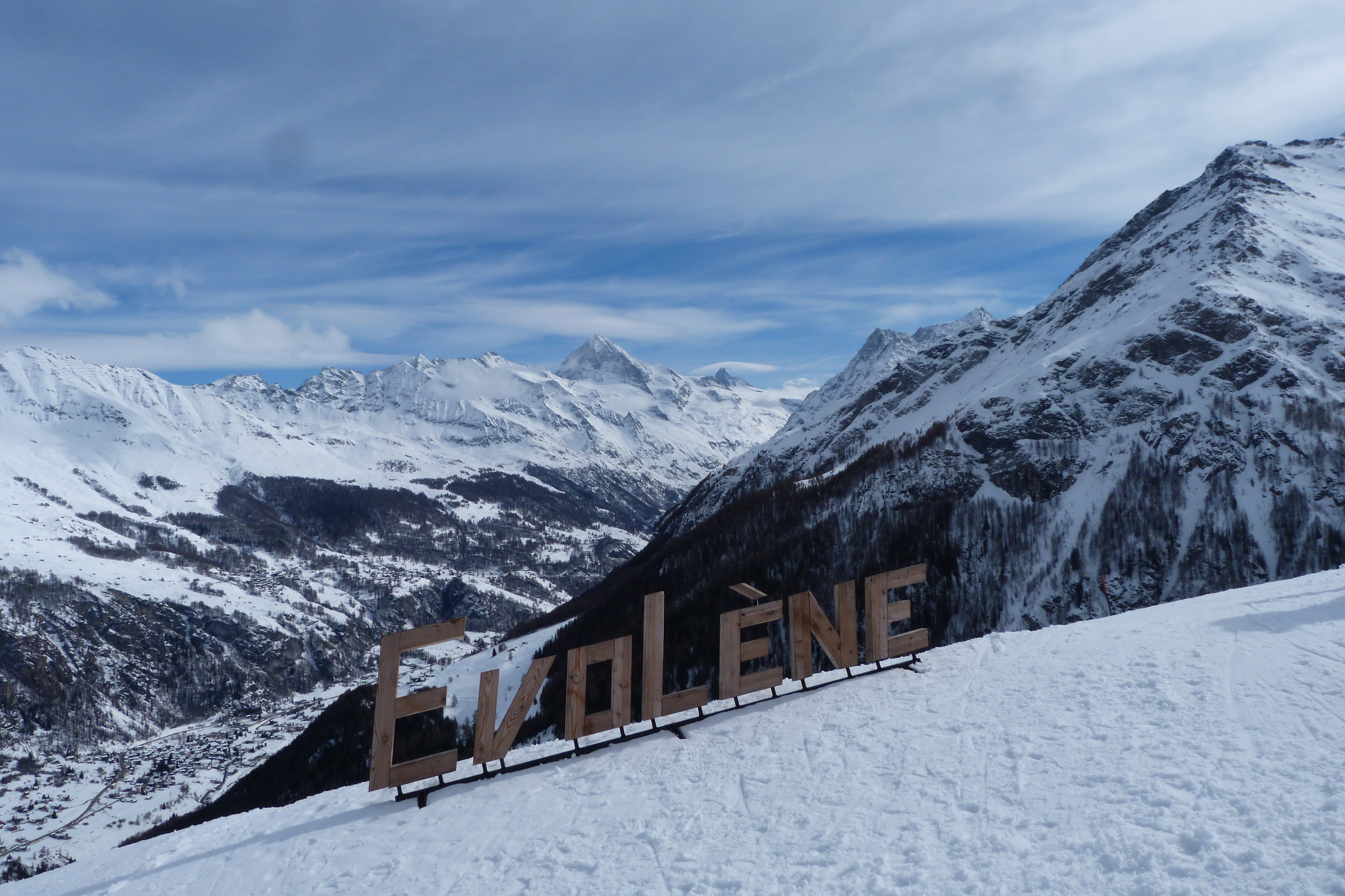 Skiers on the slopes above Évolène in the Val d'Hérens
