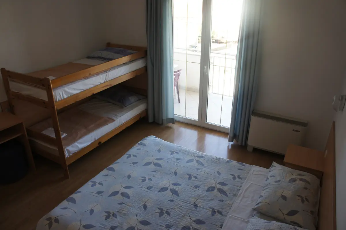 Hotel room with bunk beds and a window to the balcony