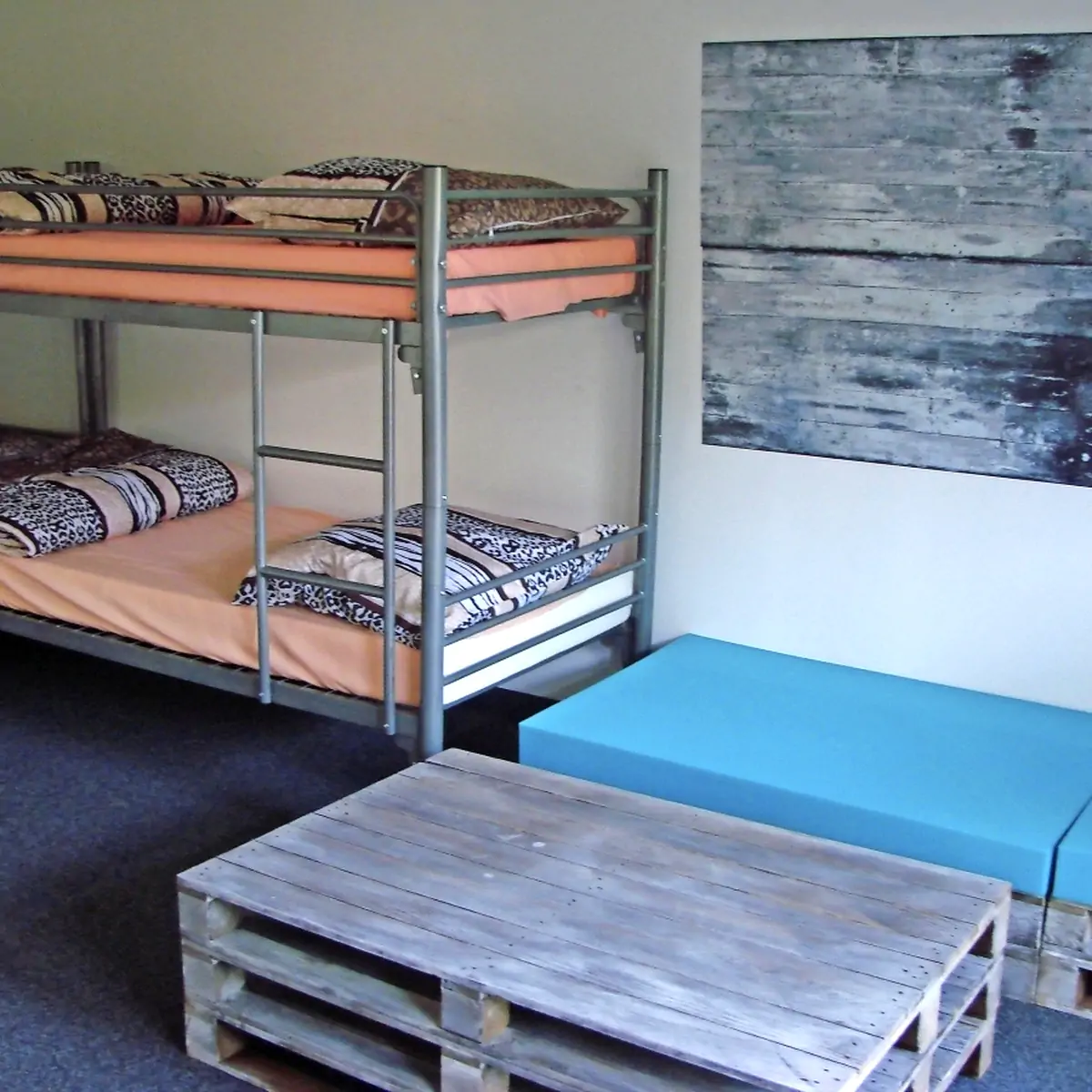 Bedroom with bunk beds, a sofa and a pallet coffee table at the Omega holiday complex