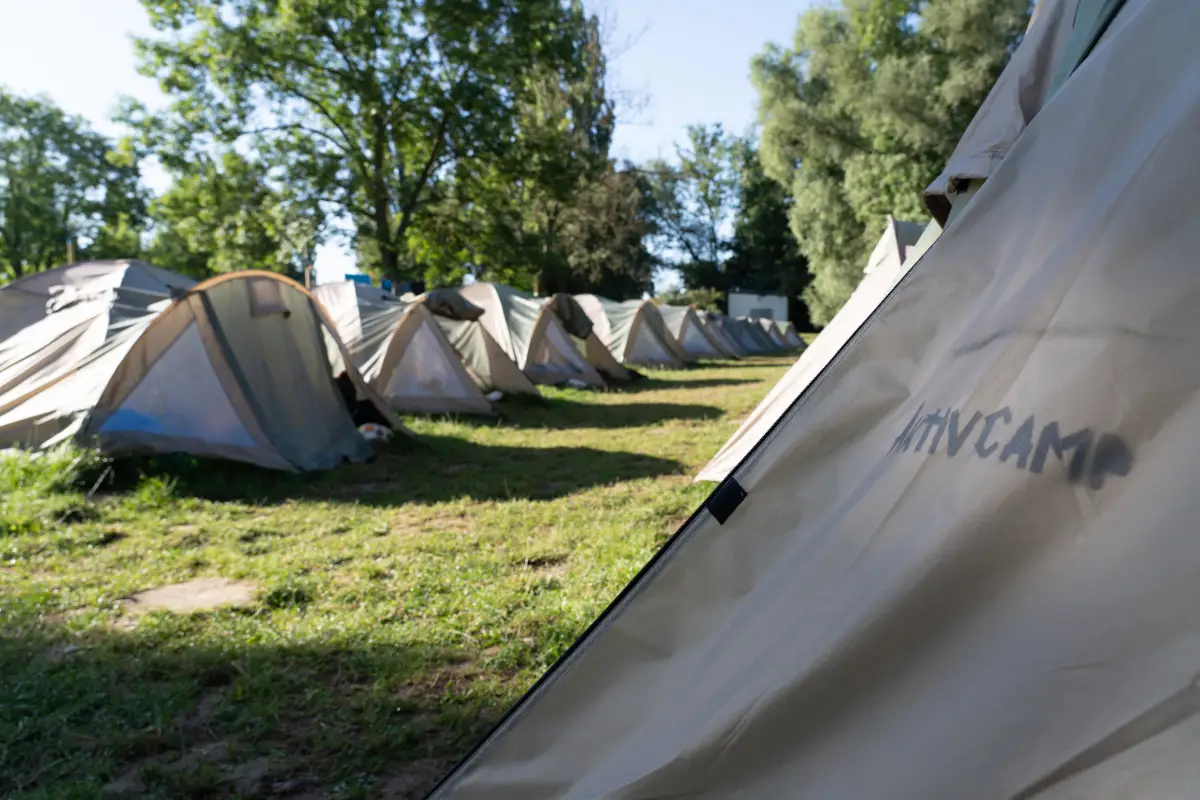 A row of igloo sleeping tents pitched on the grass at the Blütengrund campsite