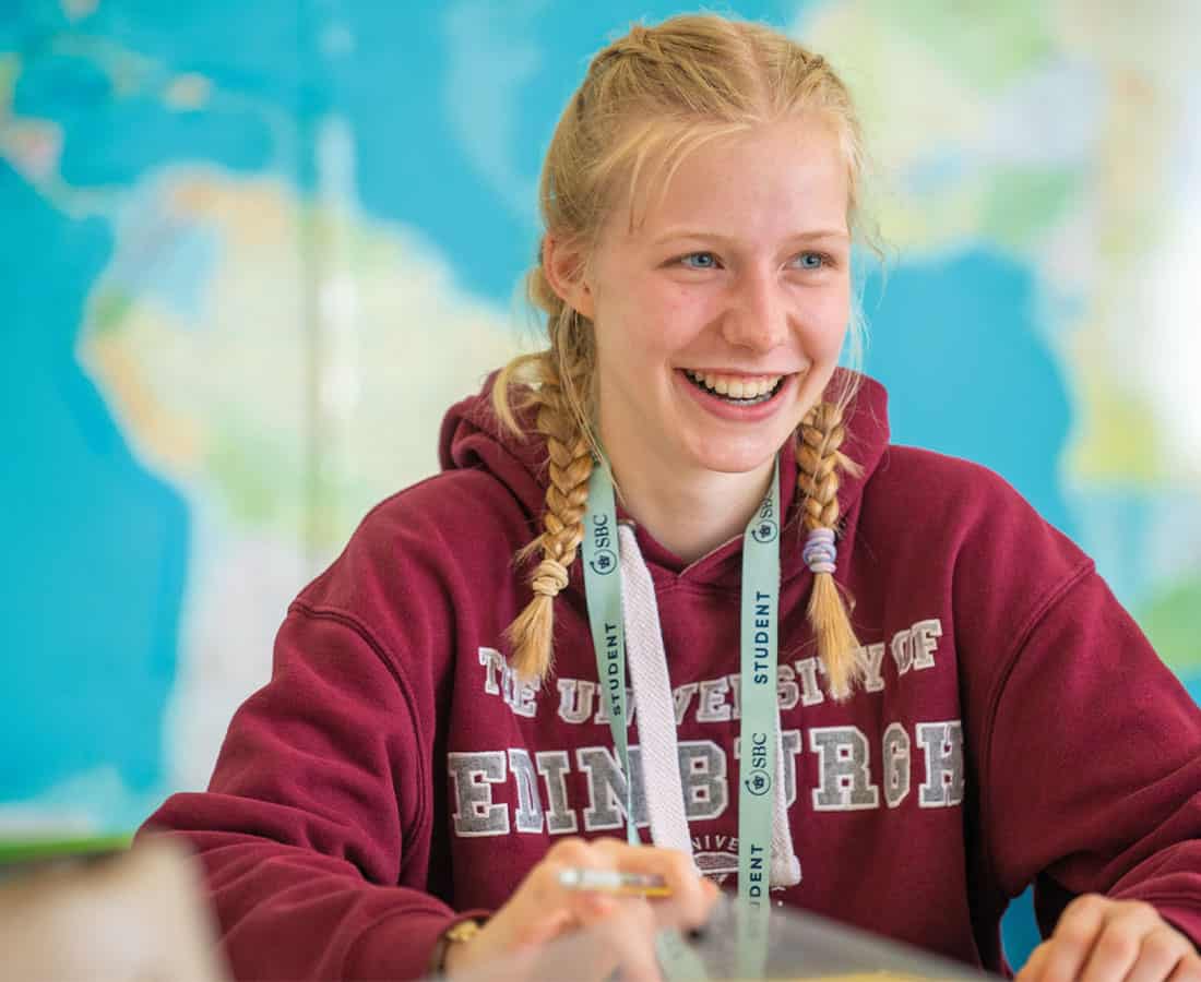 A student smiling during a summer school lesson at Headington Oxford