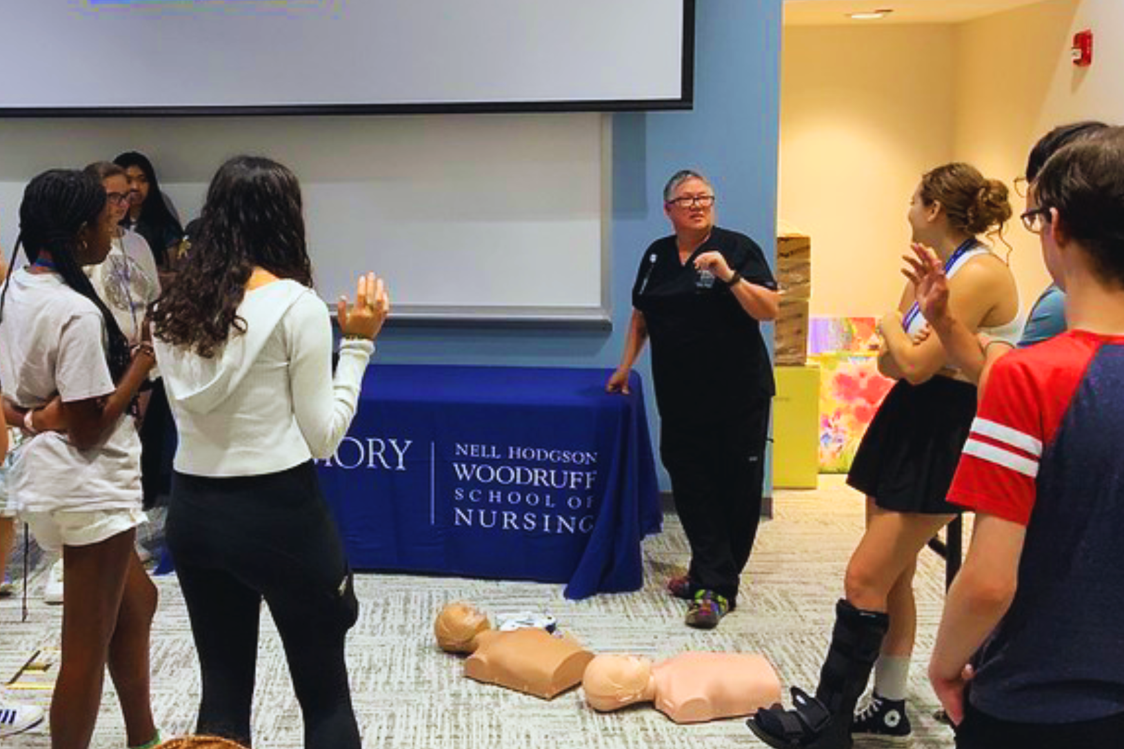 Students at a resuscitation demonstration with training manikins, run by staff of the Nell Hodgson Woodruff School of Nursing