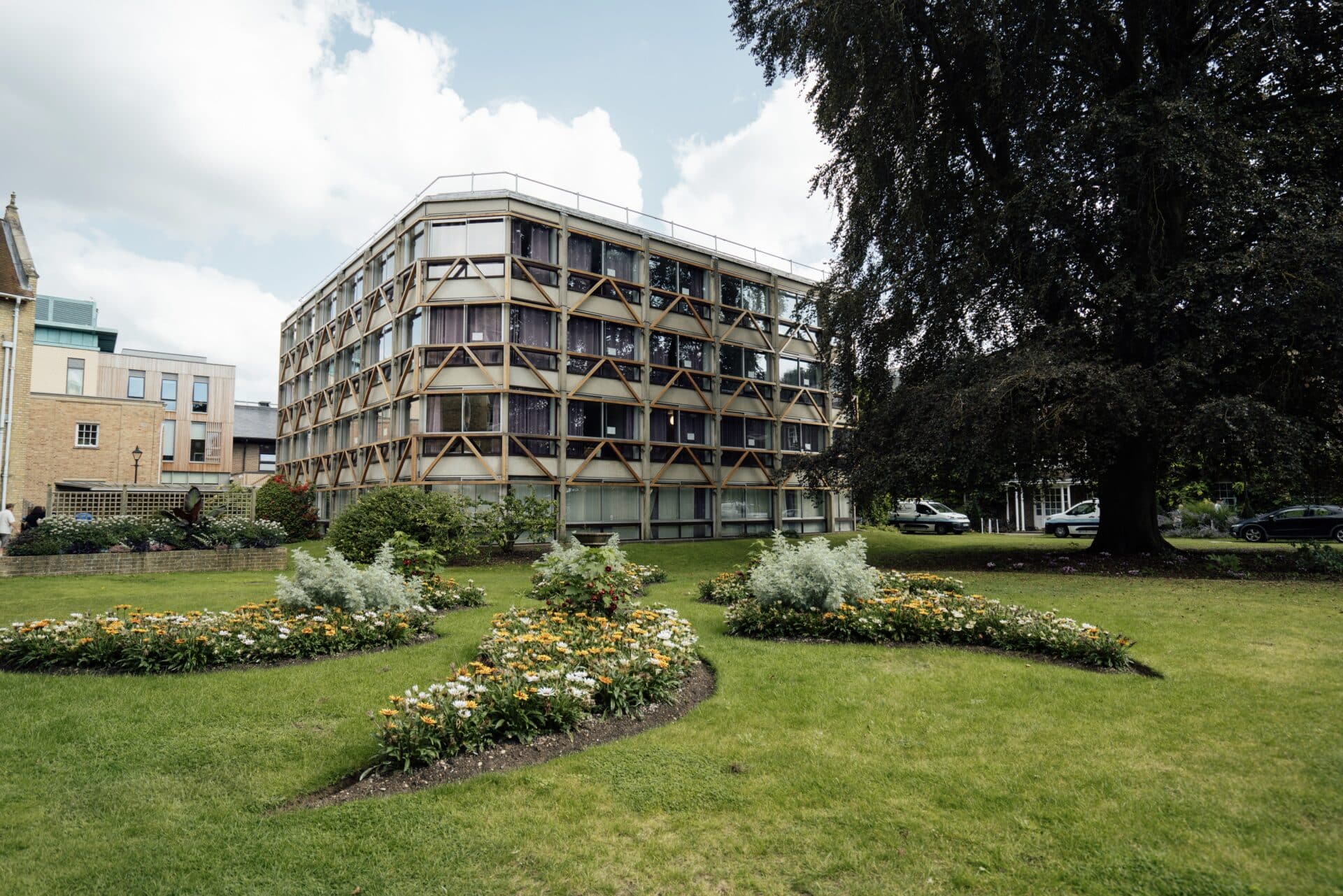 The Garden Building at St Hilda's College, Oxford, seen across a lawn with flowerbeds