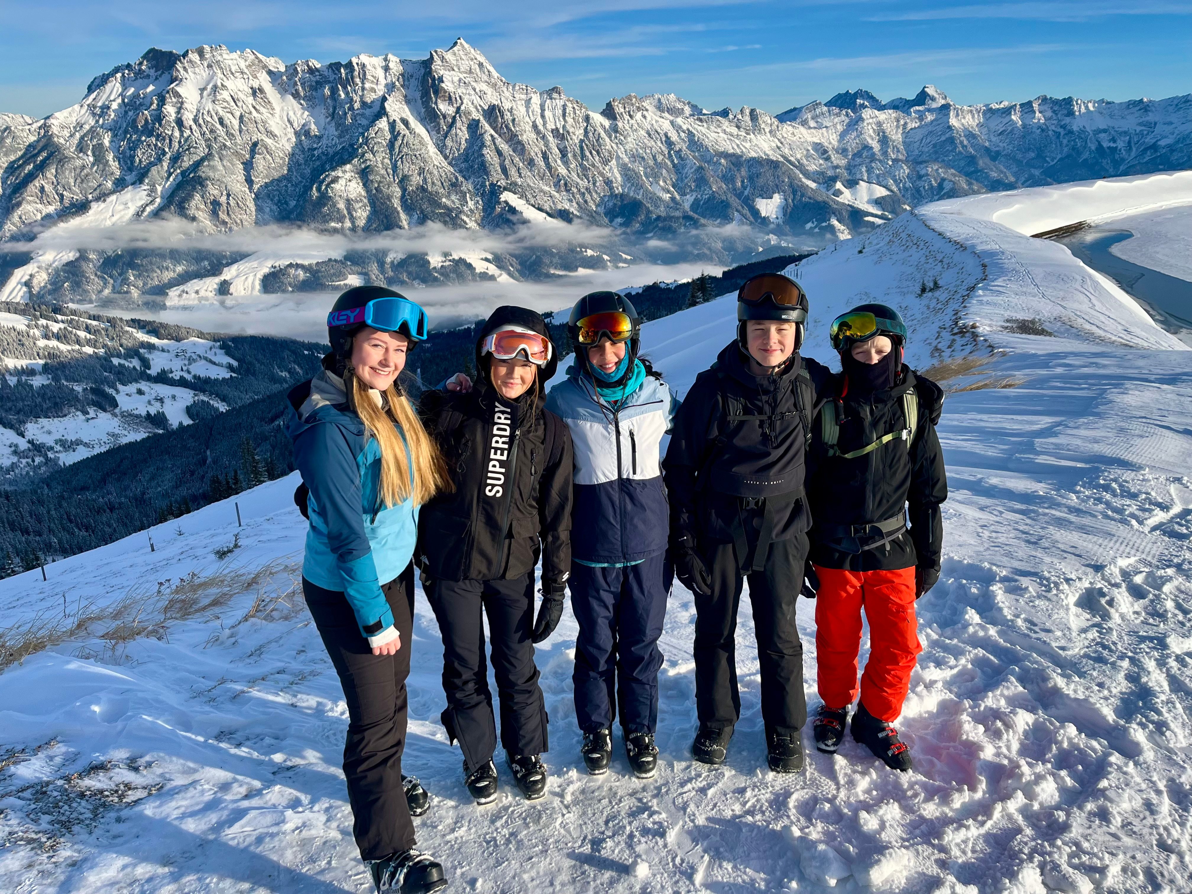Large group posing for a photo in the snow