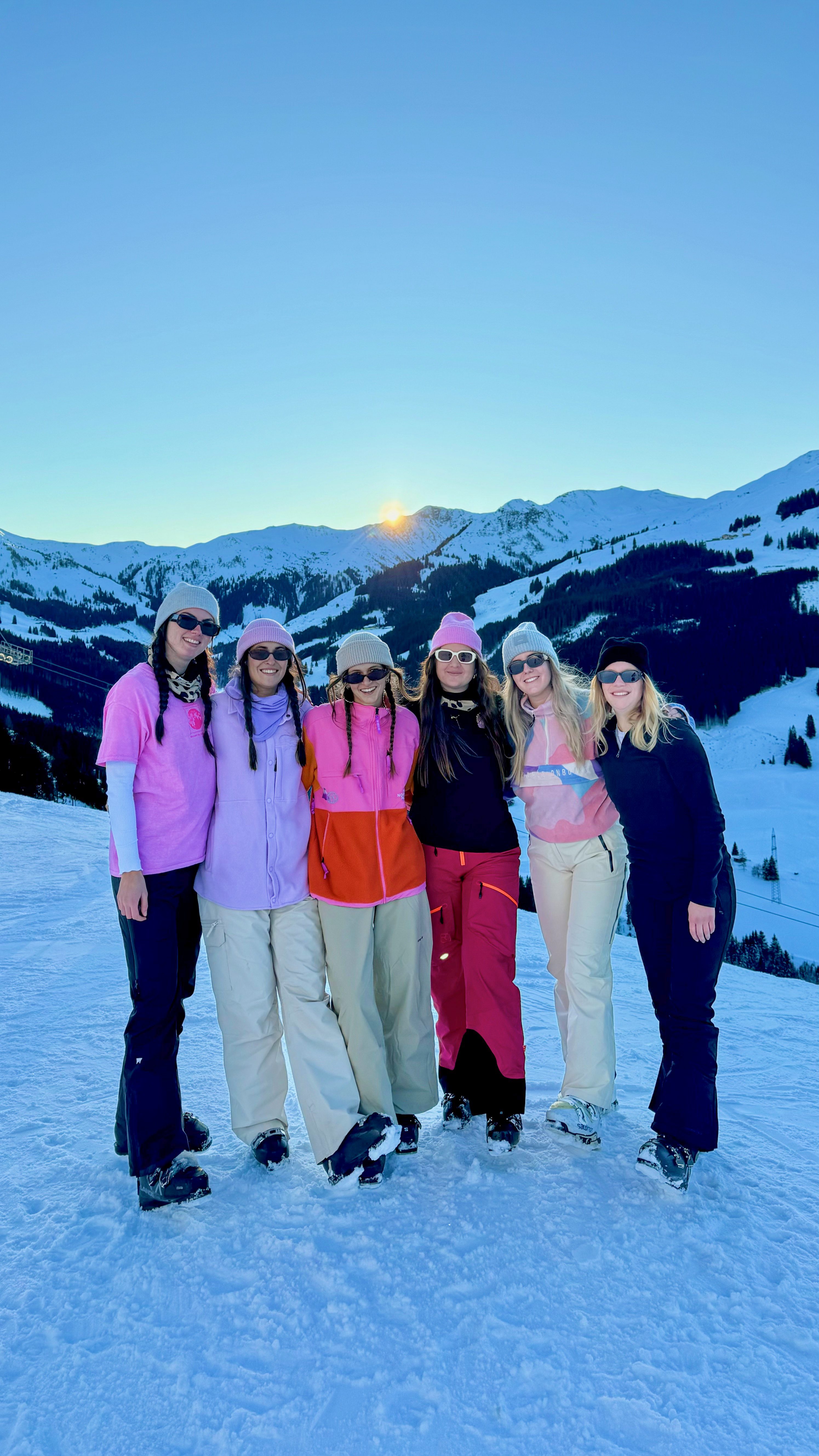 Guests in front of the mountain panorama at sunset