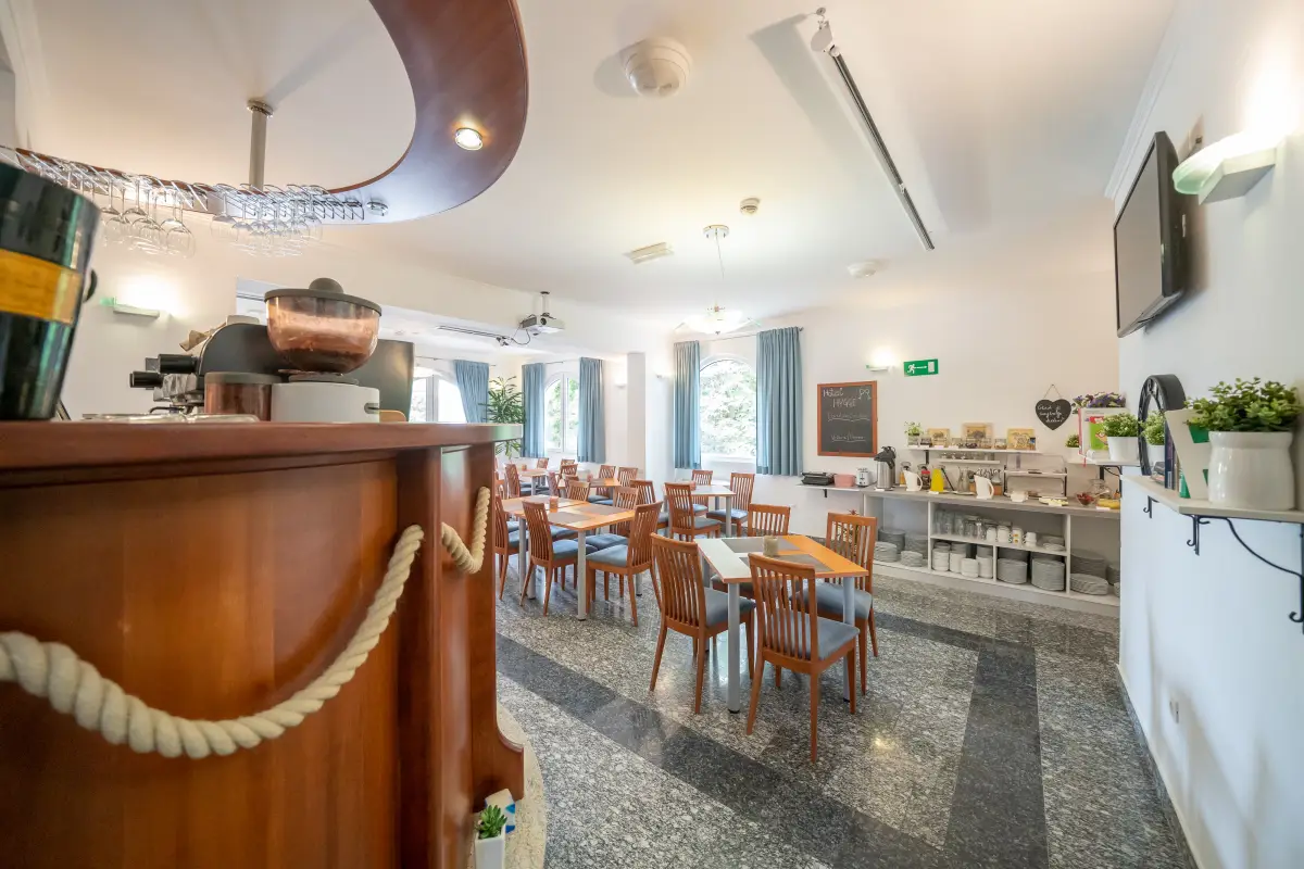 Hotel dining room with laid tables and the serving counter