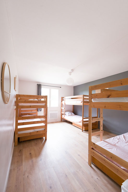 A light bedroom on the estate with wooden bunk beds where the children sleep