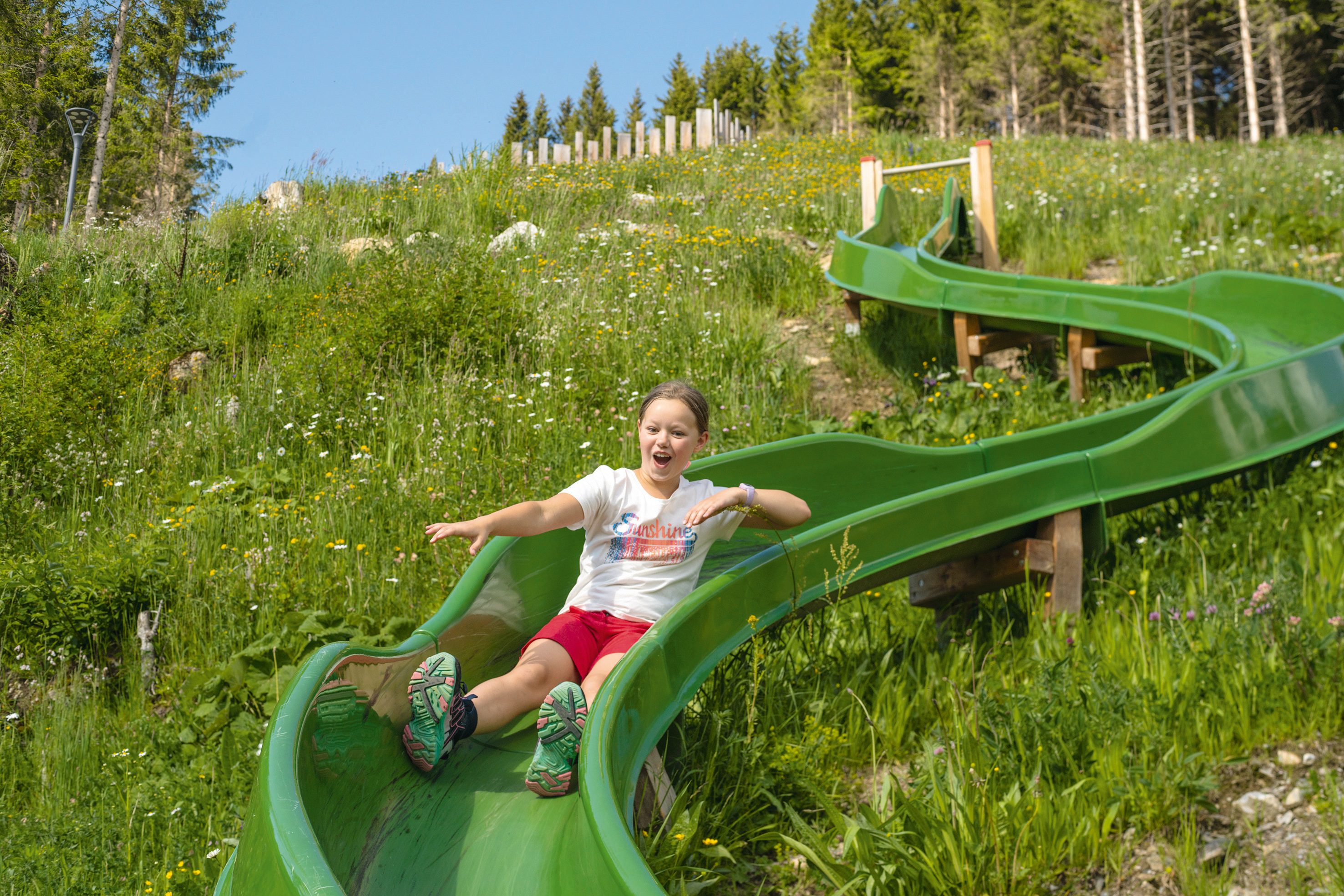 Child coming down the water fun slide