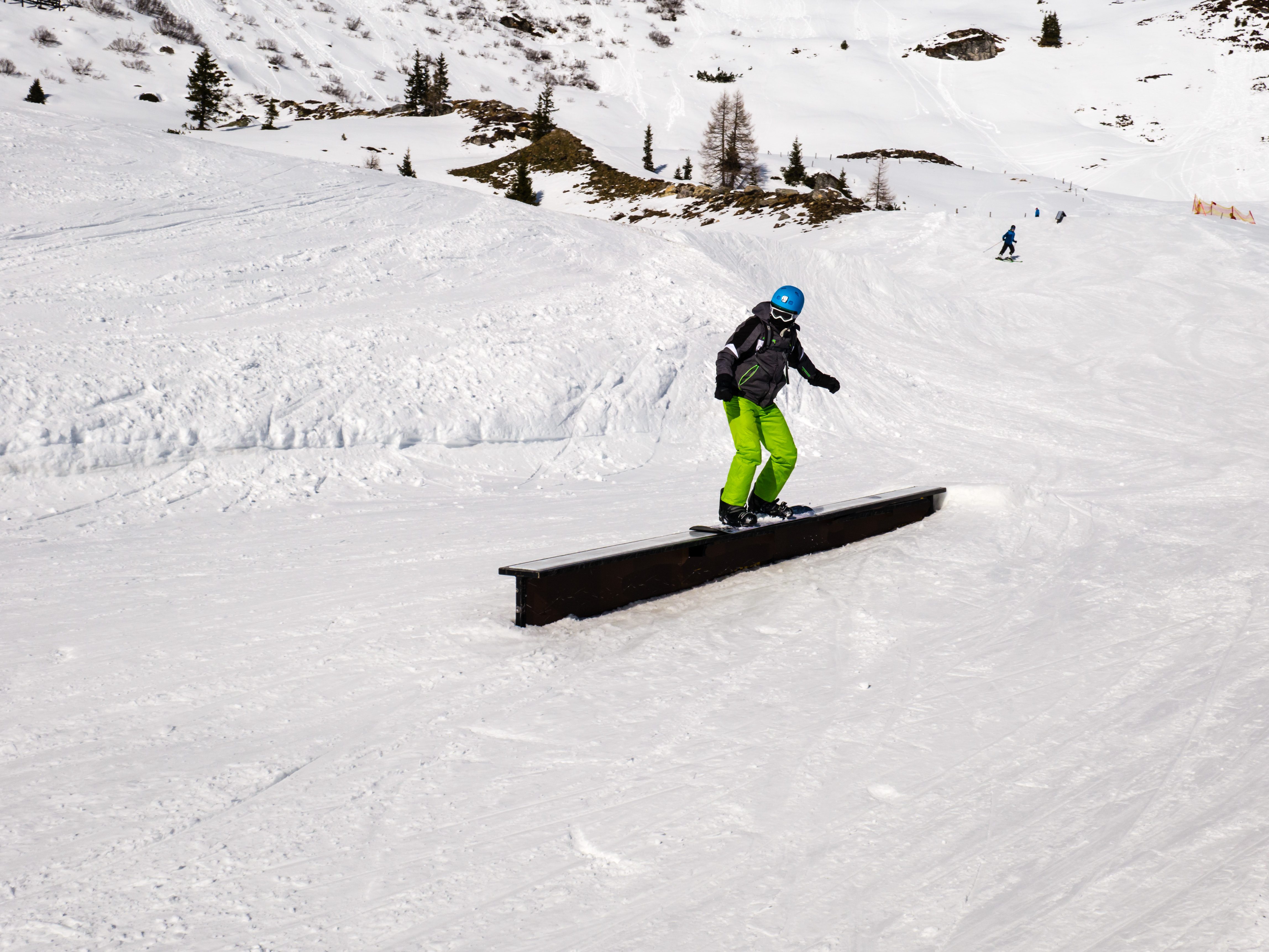 Snowboarder on a rail in the funpark