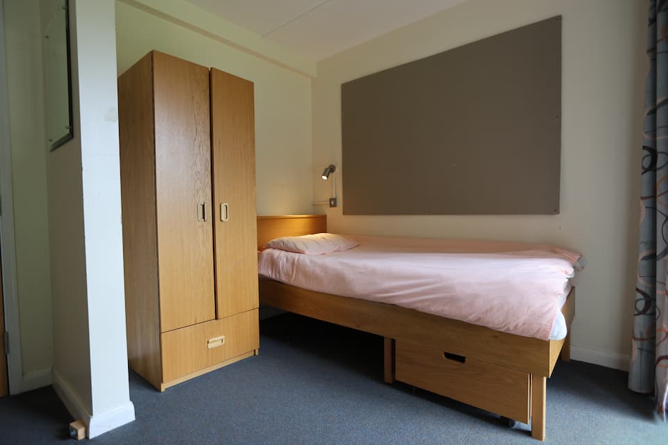 Shared student bedroom with several beds in a Winchester boarding house