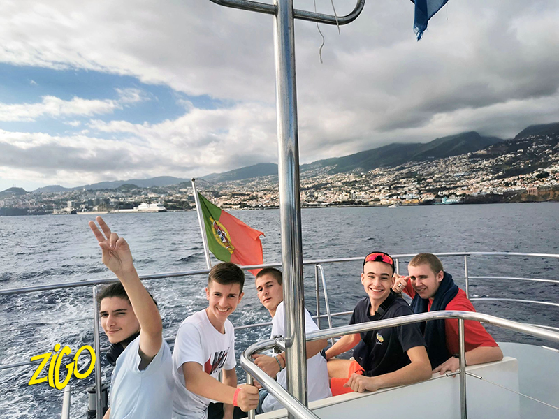 Participants on the deck of an excursion boat along the coast