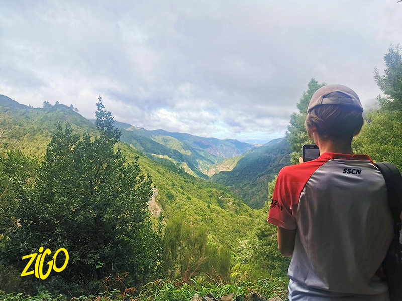 A participant looking out over a green mountain valley