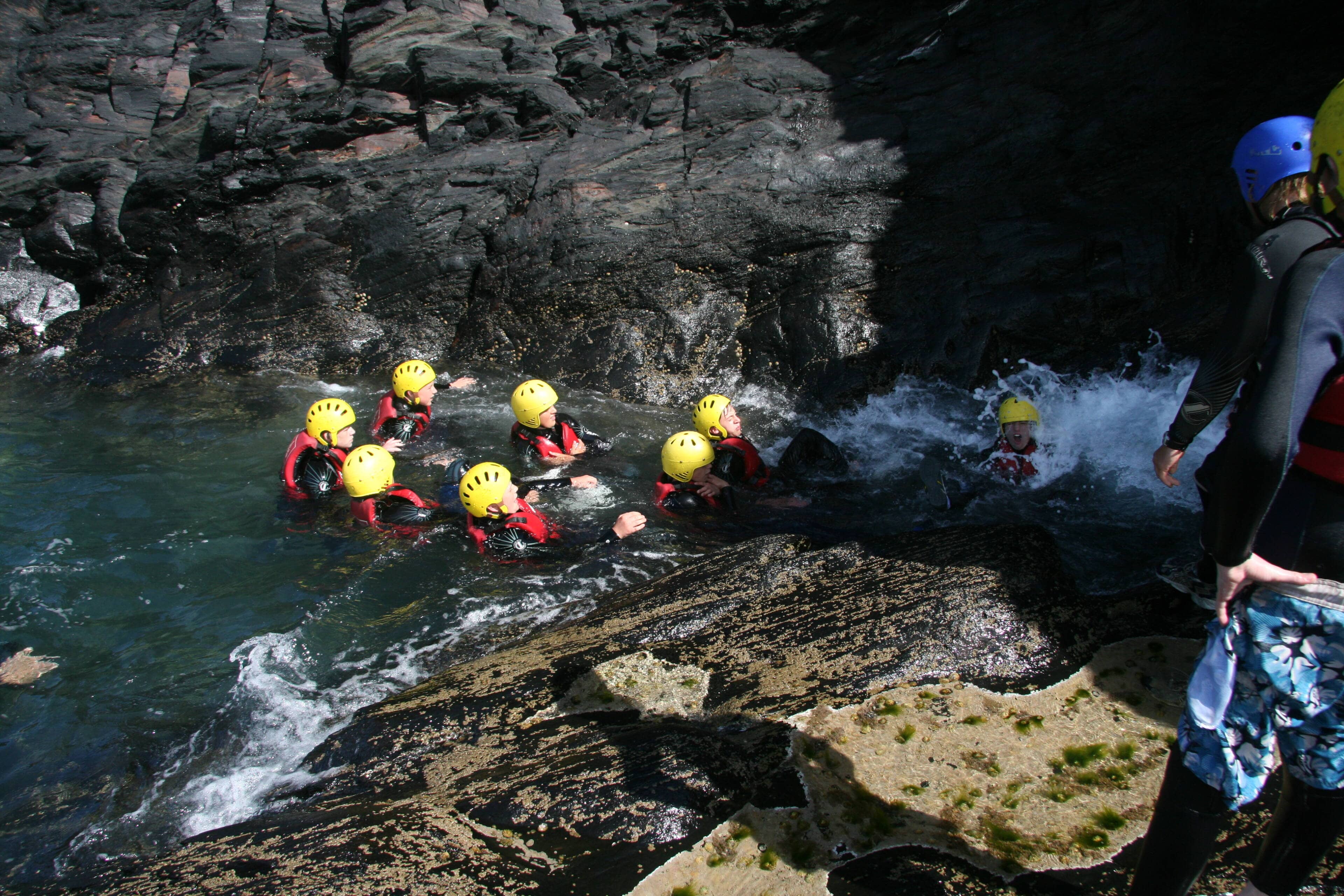 Coasteering group in the water on the Pembrokeshire coast