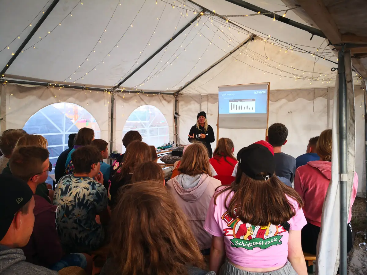 Participants seated in the group tent watching a presentation