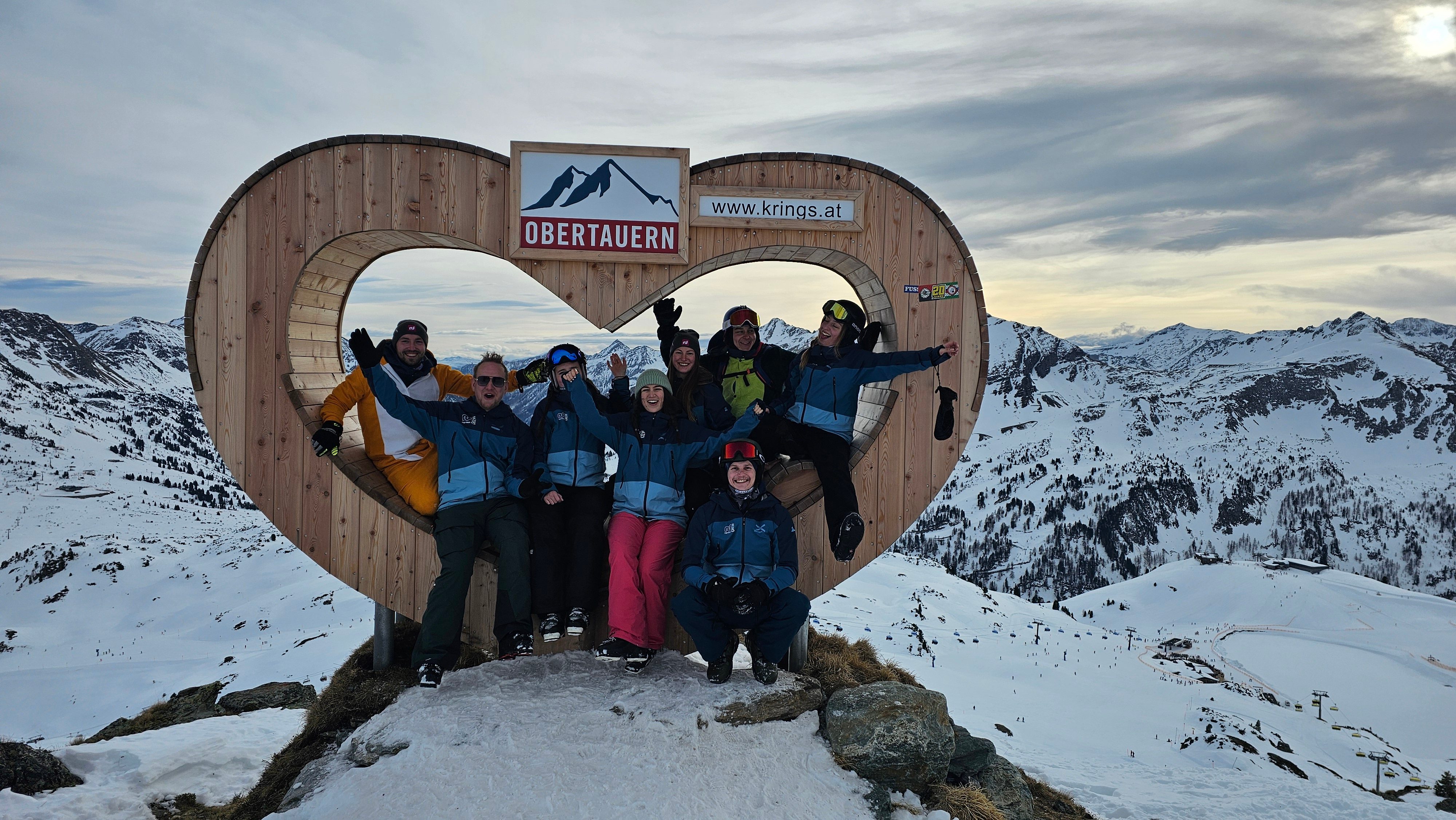 Group photo in front of snow-covered mountains