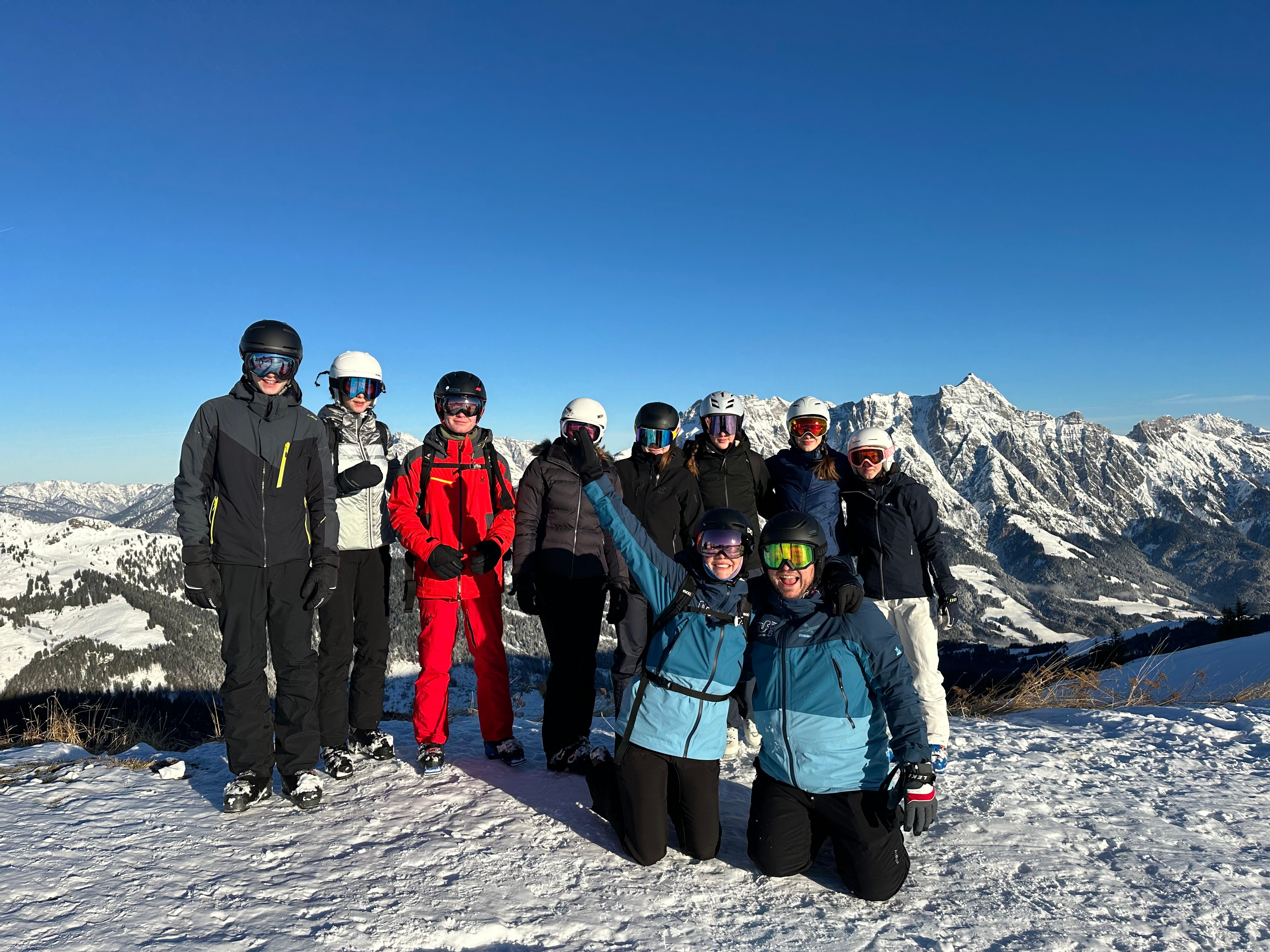 Large group posing for a photo in the snow