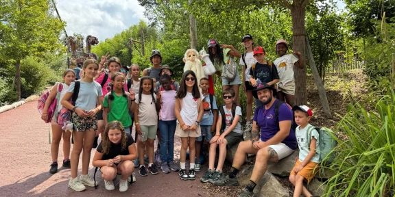 Campers and their group leaders on a wooded path in the park