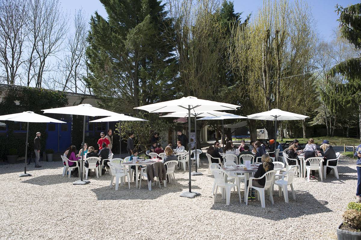 Outdoor terrace with white tables, chairs and parasols on the estate