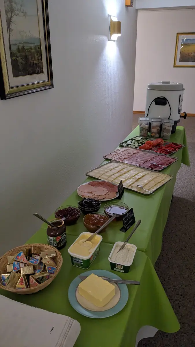 Breakfast buffet laid out with juice, fruit and cereals
