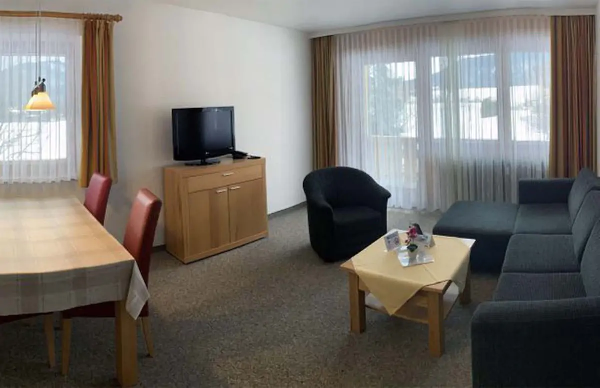 Apartment living area with sofa, table, desk and television