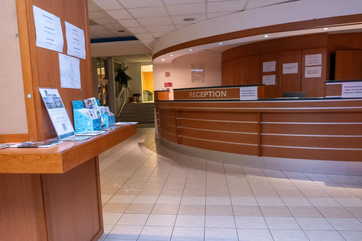 The reception desk in the lobby of the holiday complex, with a brochure stand beside it