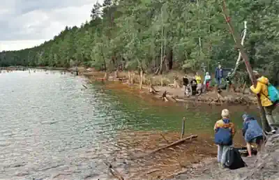 Children hiking along the lakeshore and exploring the wilderness near Weisswasser