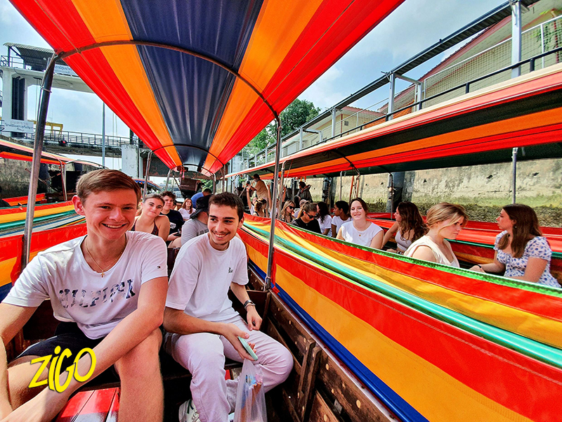 Participants aboard a long-tail boat