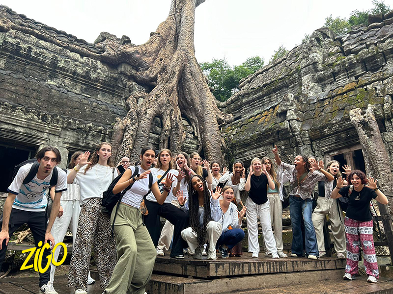The group at a temple overgrown with tree roots at Angkor