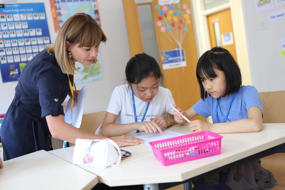 Teacher with a small group of students in an English lesson