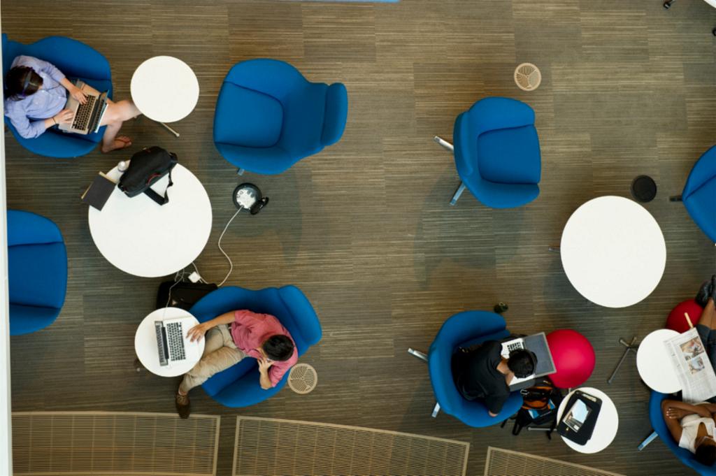 Students studying at tables in the Brody Learning Commons on the Homewood campus