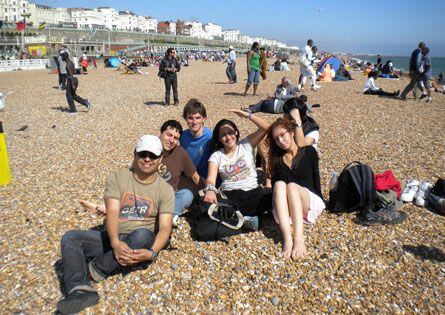 Student on Brighton beach with the seafront behind