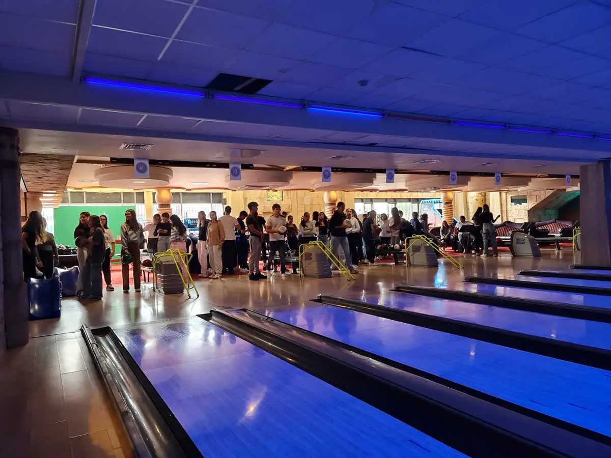 A bowling alley with lit lanes where students spend an evening social event