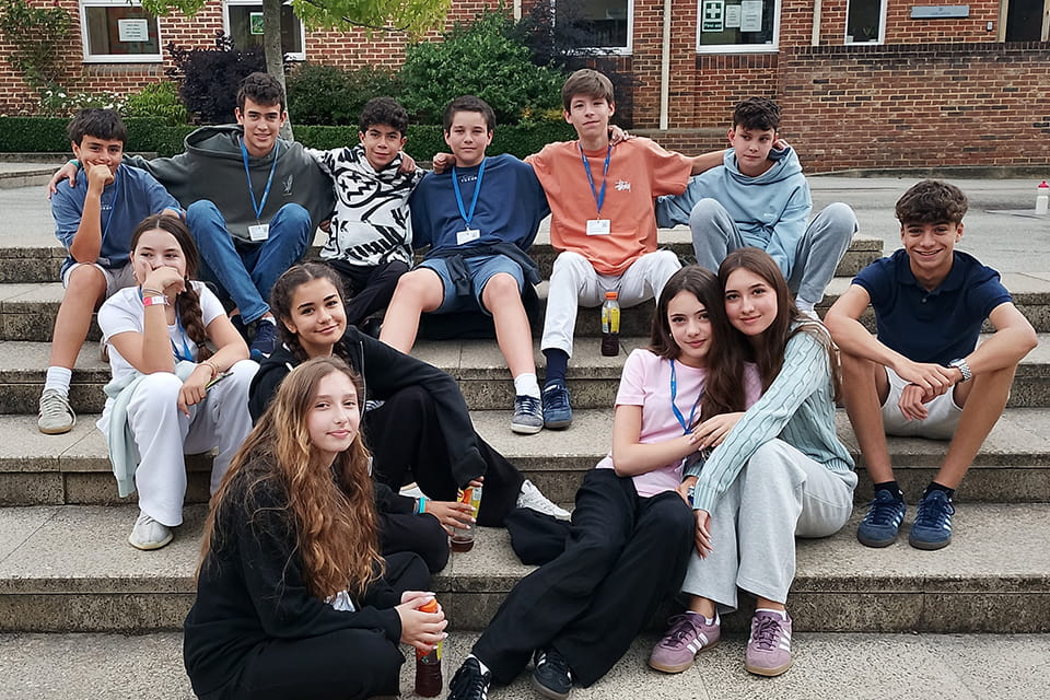 Teenagers relaxing together in a boarding house common room