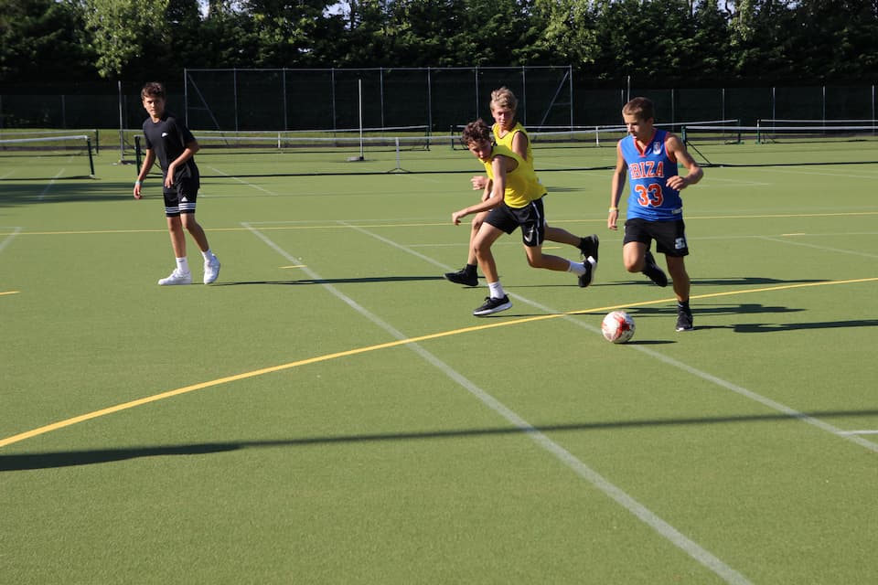 Teenagers playing football on the playing fields at Benenden