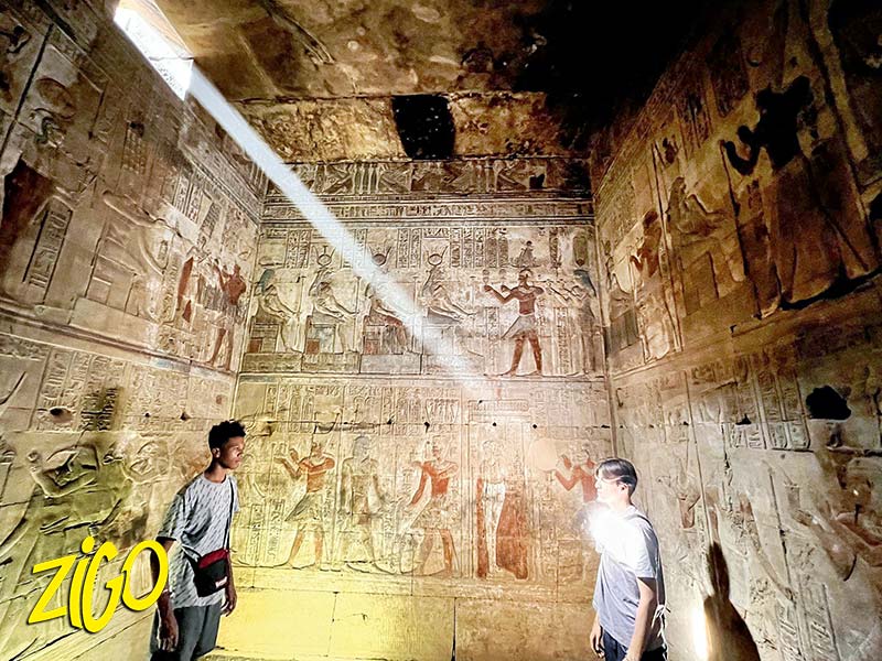 A shaft of daylight on the carved and painted reliefs covering the inner wall of a temple visited on the route