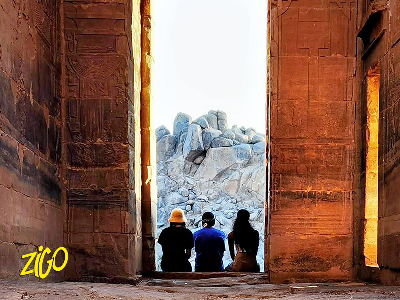 Participants standing between the great sandstone columns of a temple at Luxor