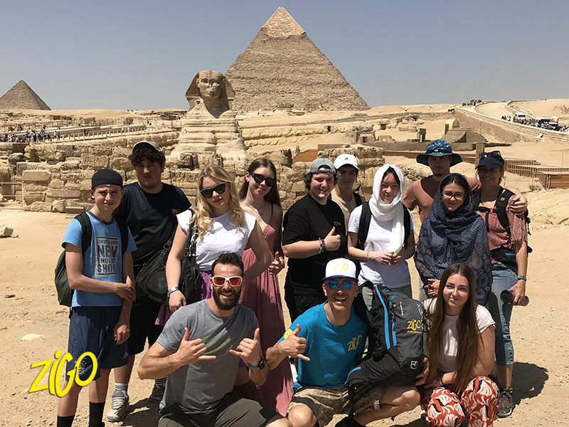 The whole group photographed in front of the Sphinx and the pyramids at Giza