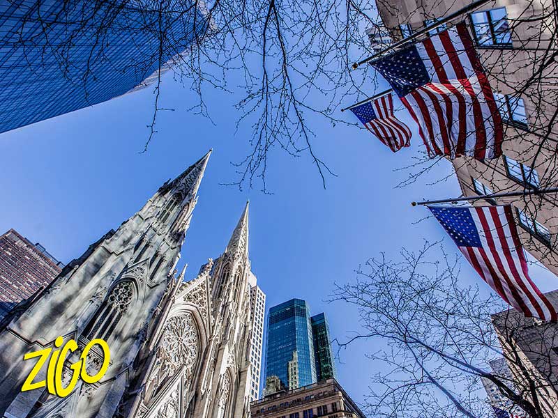 The Chrysler Building seen from below with United States flags in the foreground