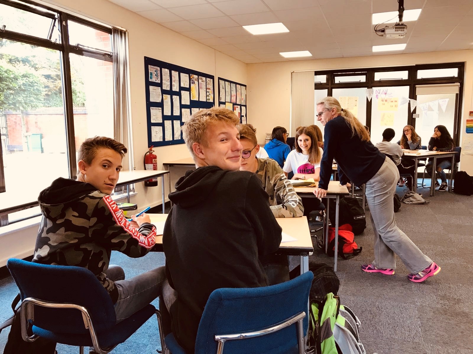 A teacher working with summer school students in an English class