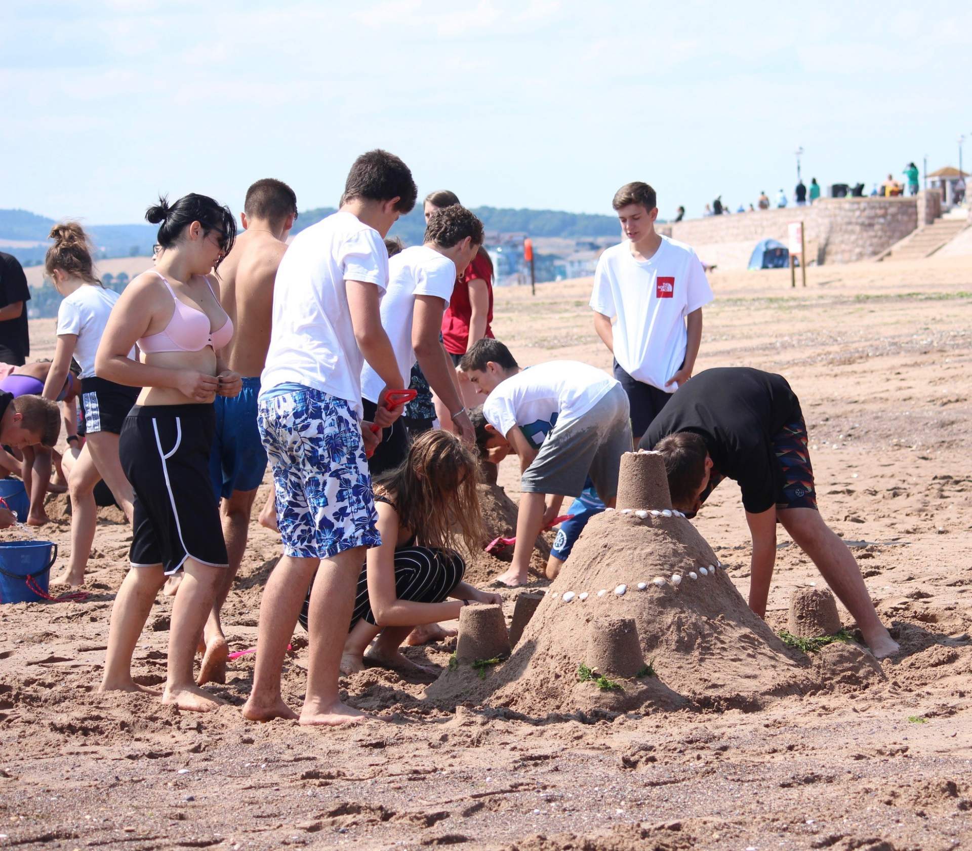 Summer school students on a Devon beach during a half-day activity