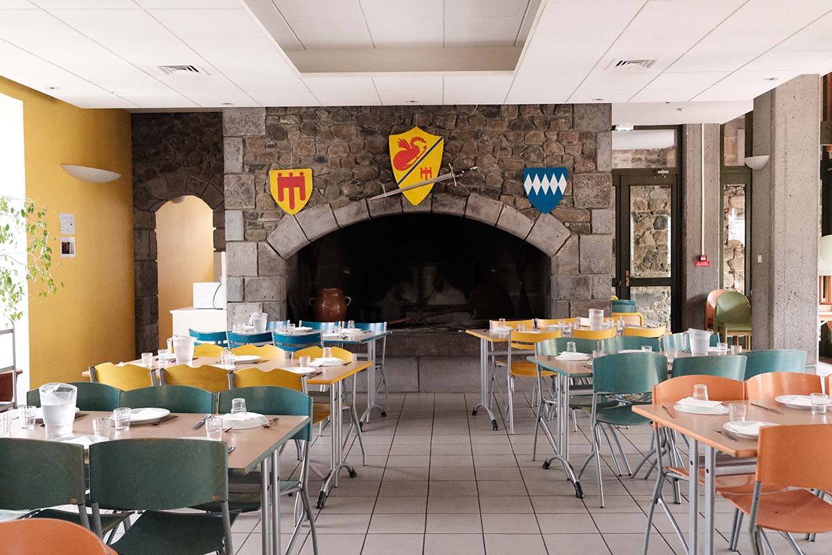 The dining room of the manor, set around its large fireplace