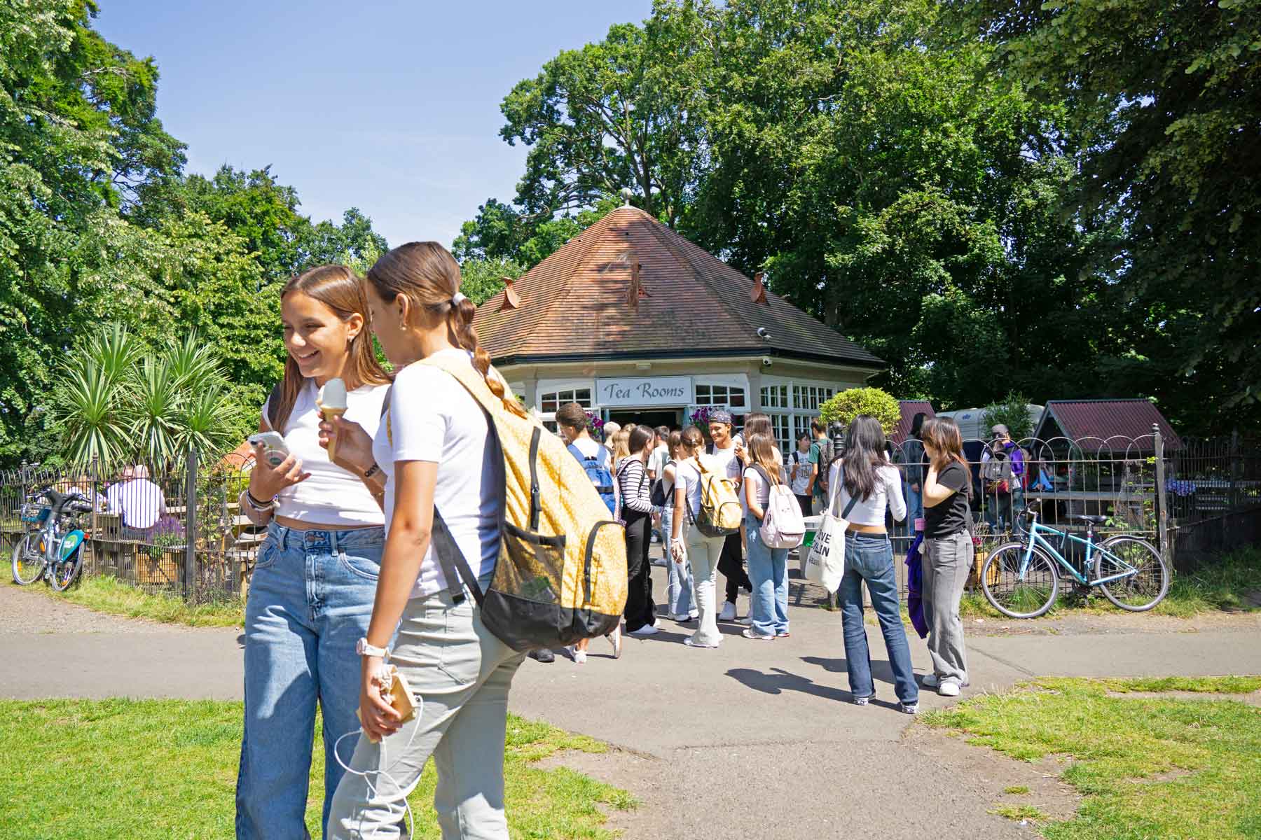 Camp students walking together along a tree-lined path during their weekly full day out in Dublin