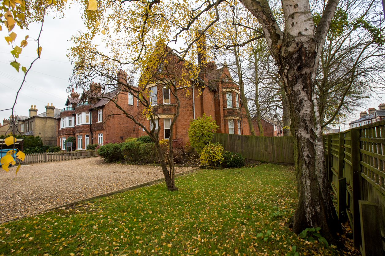 Red-brick Select English residence building with its garden and trees