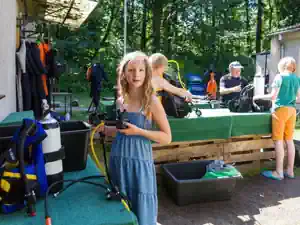 Children checking their diving equipment after a dive at the Lake Stechlin dive base