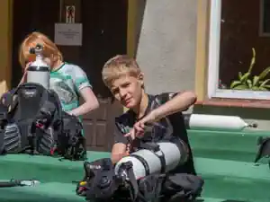 Boy assembling his scuba equipment outside the dive base at Lake Stechlin