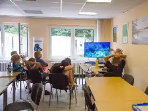 Children in a diving theory lesson in a classroom at the Lake Stechlin dive camp