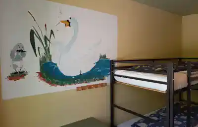 Children's bedroom with a bunk bed and a swan mural at Villa Frida